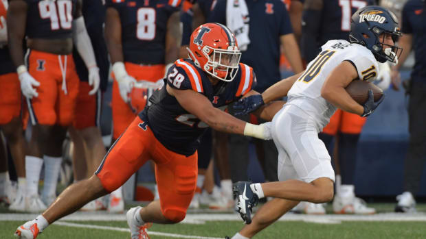 Sep 2, 2023; Champaign, Illinois, USA; Toledo Rockets wide receiver Jermaine Foster (10) tries to elude the tackle of \Illinois Fighting Illini linebacker Dylan Rosiek (28)during the first half at Memorial Stadium. Mandatory Credit: Ron Johnson-USA TODAY Sports  