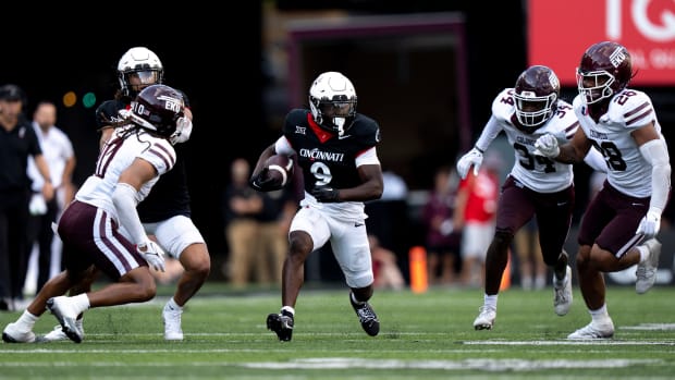 Cincinnati Bearcats wide receiver Aaron Turner (9) runs downfield as Eastern Kentucky Colonels linebacker Jaylen Herrud (28), Eastern Kentucky Colonels defensive back Kyeaure Magloire (34), and Eastern Kentucky Colonels defensive back Nic Cheeley (10) runs downfield in the third quarter of the NCAA football game between the Cincinnati Bearcats and the Eastern Kentucky Colonels at Nippert Stadium in Cincinnati on Saturday, Sept. 2, 2023.