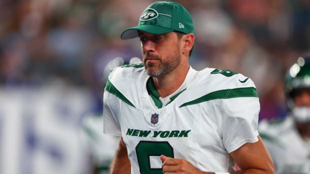 Jets quarterback Aaron Rodgers jogs off the field after a preseason game vs. the Giants.