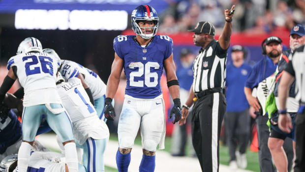 Sep 10, 2023; East Rutherford, New Jersey, USA; New York Giants running back Saquon Barkley (26) reacts after an interception by Dallas Cowboys cornerback Stephon Gilmore (21) during the first half at MetLife Stadium.