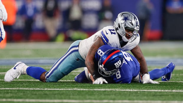 Dallas Cowboys' Micah Parsons (11), top, tackles New York Giants quarterback Daniel Jones during the first half of an NFL football game, Sunday, Sept. 10, 2023, in East Rutherford, N.J. (AP Photo/Adam Hunger)   