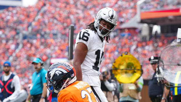 Las Vegas Raiders wide receiver Jakobi Meyers (16) reacts towards Denver Broncos cornerback Damarri Mathis (27) following his touchdown reception in the first quarter at Empower Field at Mile High.