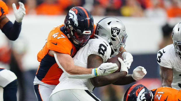 Denver Broncos linebacker Josey Jewell (47) tackles Las Vegas Raiders running back Josh Jacobs (8) in the third quarter at Empower Field at Mile High.