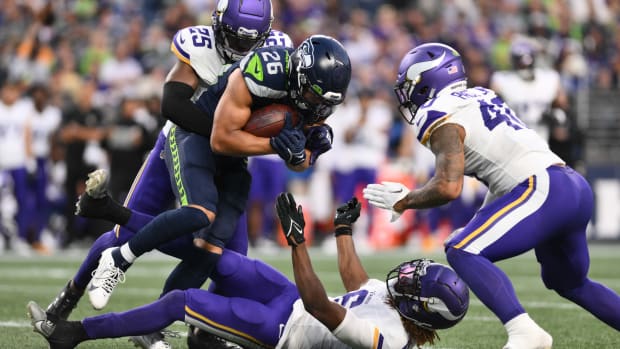 Aug 10, 2023; Seattle, Washington, USA; Minnesota Vikings safety Theo Jackson (25) and linebacker Ivan Pace Jr. (40) tackle Seattle Seahawks running back Zach Charbonnet (26) during the game at Lumen Field. Mandatory Credit: Steven Bisig-USA TODAY Sports