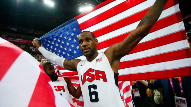 Aug 12, 2012; London, United Kingdom; USA forward LeBron James (6) celebrates with an American flag after defeating Spain 107-100 during the men's basketball gold medal game in the London 2012 Olympic Games at North Greenwich Arena. Mandatory Credit: Rob Schumacher-USA TODAY Sports