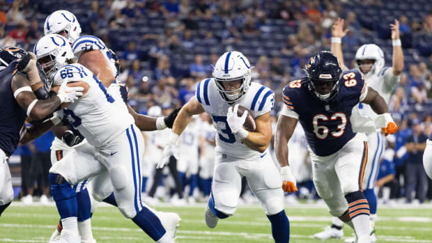 Aug 19, 2023; Indianapolis, Indiana, USA; Indianapolis Colts running back Jake Funk (37) runs the ball for the go ahead touchdown while Chicago Bears defensive tackle D'Anthony Jones (63) defends in the second half at Lucas Oil Stadium.