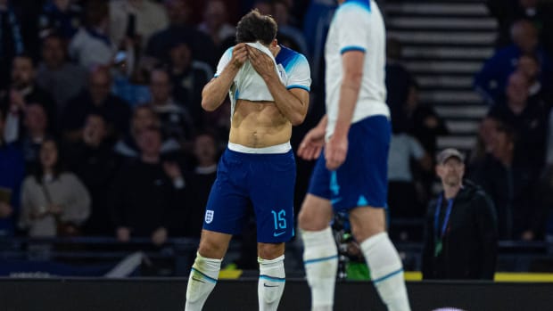 Harry Maguire pictured covering his face with his England jersey after scoring an own goal against Scotland in September 2023