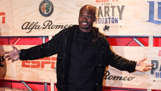 Vikings running back Adrian Peterson poses for a photo on the red carpet at the ESPN the Party event in the Houston arts district.