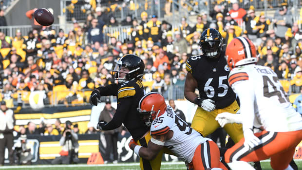Jan 8, 2023; Pittsburgh, Pennsylvania, USA; Pittsburgh Steelers quarterback Kenny Pickett (8) releases the ball as he is hit by Cleveland Browns dfensive end Myles Garrett (95) during the second quarter at Acrisure Stadium. Mandatory Credit: Philip G. Pavely-USA TODAY Sports