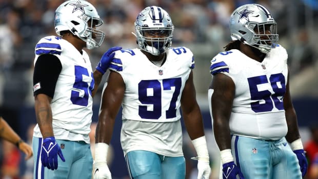 Cowboys defensive lineman Osa Odighizuwa, Sam Williams and Mazi Smith stand in between plays during a game.