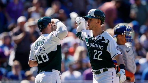 Sep 13, 2023; Denver, Colorado, USA; Colorado Rockies left fielder Nolan Jones (22) celebrates with catcher Austin Wynns (16) on his two run home run in the fifth inning against the Chicago Cubs at Coors Field.