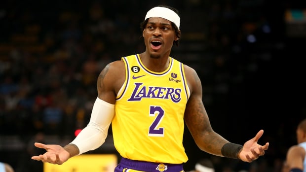 Lakers forward Jarred Vanderbilt holds up his hands during a game against the Grizzlies.