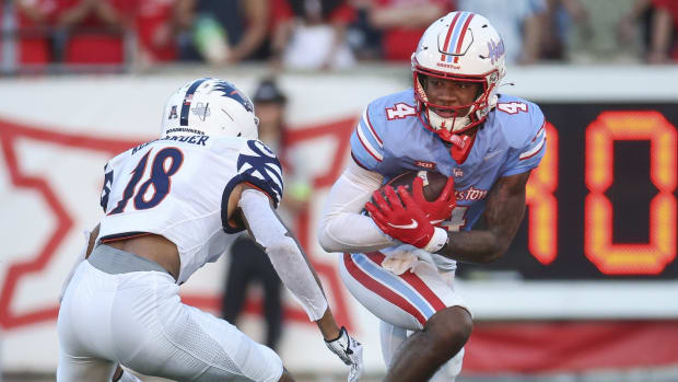 Houston Cougars wide receiver Samuel Brown (4) runs with the ball after a reception as UTSA Roadrunners cornerback Kam Alexander (18) defends during the second quarter at TDECU Stadium.