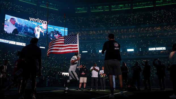 Aaron Rodgers runs out onto the field with the American Flag on the anniversary of 9/11