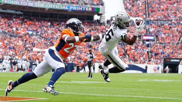 Las Vegas Raiders wide receiver Jakobi Meyers (16) pulls in a touchdown past Denver Broncos cornerback Damarri Mathis (27) in the first quarter at Empower Field at Mile High.