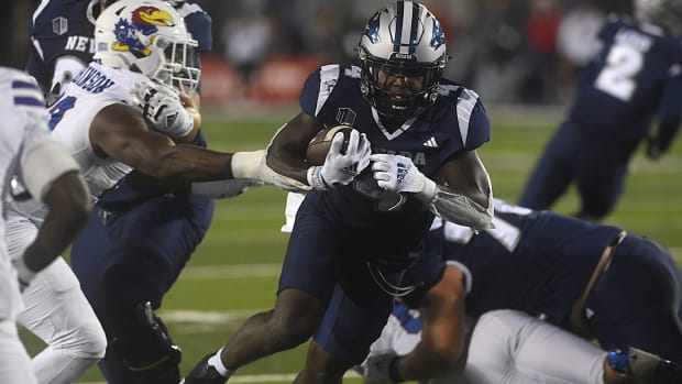 Nevada s Sean Dollars (4) runs it in for a score while taking on Kansas at Mackay Stadium in Reno on Sept. 16, 2023.  