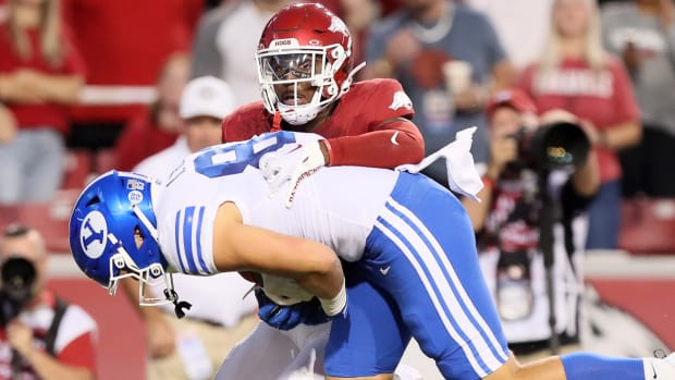 Razorbacks Alfahiym Walcott drags down BYU's Parker Kingston after another completion