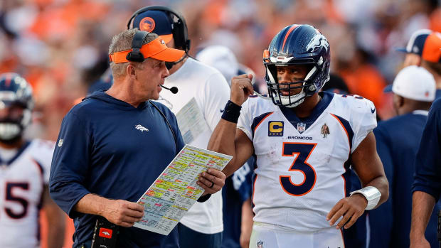 Denver Broncos head coach Sean Payton talks with quarterback Russell Wilson (3) in the fourth quarter against the Washington Commanders at Empower Field at Mile High.