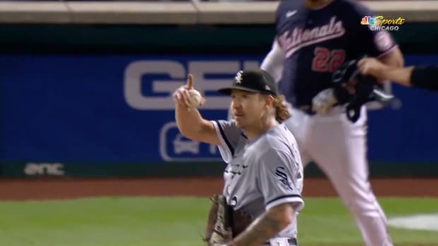 Mike Clevinger points at the scoreboard while Dominic Smith yells at him