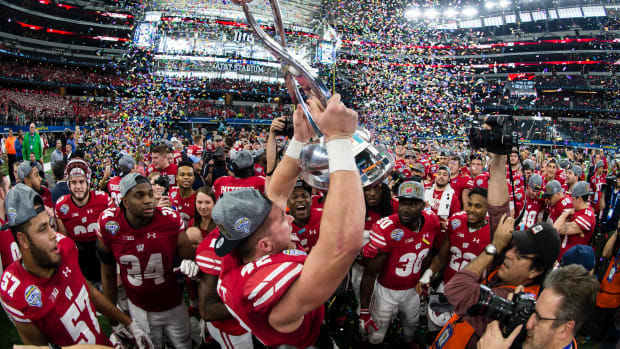 Jan 2, 2017; Arlington, TX, USA; Wisconsin Badgers linebacker T.J. Watt (42) holds up the Cotton Bowl trophy after defeating the Western Michigan Broncos 24-16 at AT&T Stadium. Mandatory Credit: Jerome Miron-USA TODAY Sports