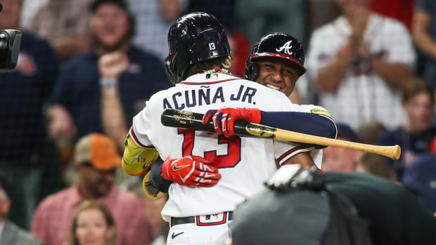 Sep 19, 2023; Atlanta, Georgia, USA; Atlanta Braves right fielder Ronald Acuna Jr. (13) celebrates with second baseman Ozzie Albies (1) after a home run against the Philadelphia Phillies in the sixth inning at Truist Park.