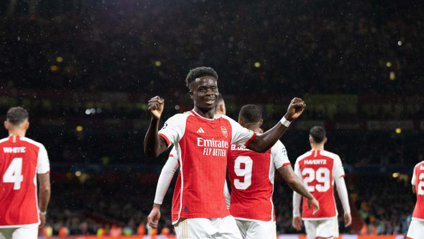 Bukayo Saka pictured (center) after scoring for Arsenal on his UEFA Champions League debut against PSV Eindhoven in September 2023