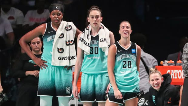 Jonquel Jones, Breanna Stewart and Sabrina Ionescu on the sidelines during a New York Liberty game