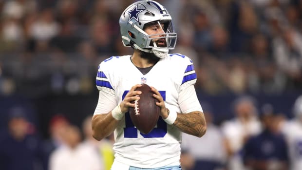 Cowboys quarterback Will Grier drops back to pass in a preseason game.
