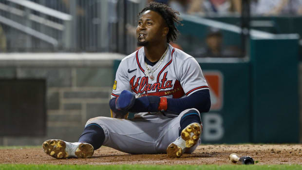 Sep 21, 2023; Washington, District of Columbia, USA; Atlanta Braves second baseman Ozzie Albies (1) sits at home plate after scoring a run on a single by Braves third baseman Austin Riley (not pictured) against the Washington Nationals during the third inning at Nationals Park.