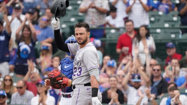 Sep 22, 2023; Chicago, Illinois, USA; Colorado Rockies first baseman Kris Bryant (23) and former Cubs player tips his cap to the fans during the first inning at Wrigley Field. Mandatory Credit: David Banks-USA TODAY Sports