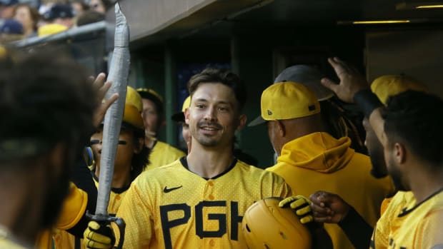 Sep 16, 2023; Pittsburgh, Pennsylvania, USA; Pittsburgh Pirates left fielder Bryan Reynolds (10) celebrtaes with a toy sword in the dugout after hitting a two run home run against the New York Yankees during the first inning at PNC Park.
