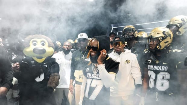 Deion Sanders waits with Lil Wayne in the tunnel at Folsom Field before the Rocky Mountain Showdown