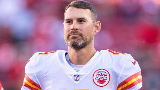 Chiefs quarterback Chad Henne looks on without a helmet before a game.