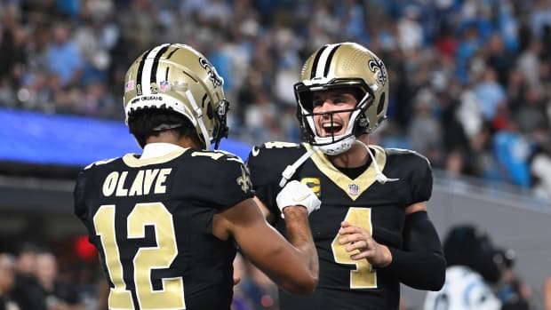 New Orleans Saints quarterback Derek Carr (4) reacts with wide receiver Chris Olave (12) in the fourth quarter