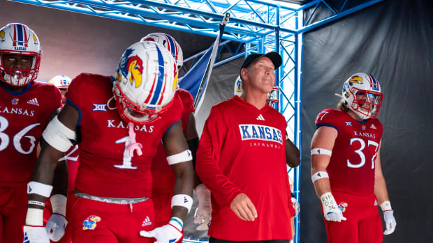 Sep 23, 2023; Lawrence, Kansas, USA; Kansas Jayhawks head coach Lance Leipold leads his team onto the field prior to a game against the Brigham Young Cougars at David Booth Kansas Memorial Stadium. 