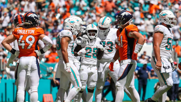 Miami Dolphins running back De'Von Achane (28) celebrates after scoring a touchdown against the Denver Broncos in the second quarter at Hard Rock Stadium.