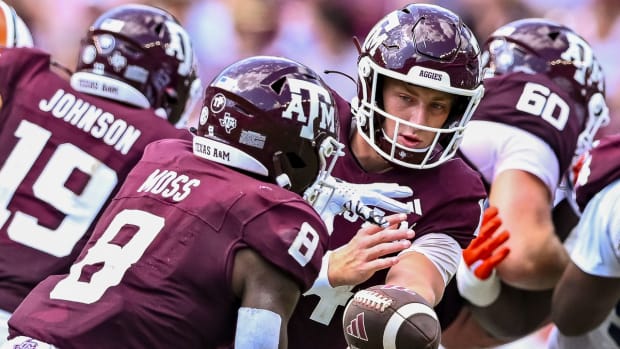 Texas A&M's Max Johnson hands off to running back Le'Veon Miss against Auburn