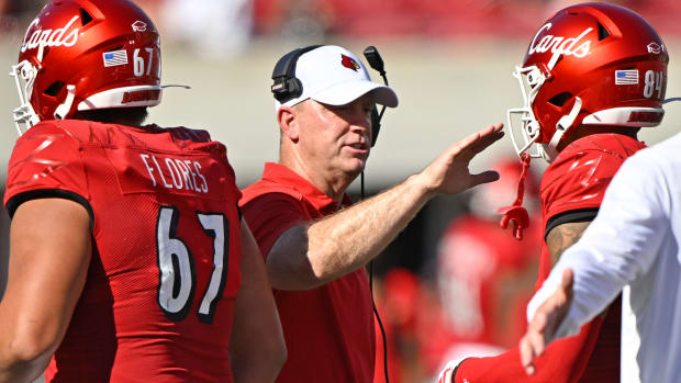 Louisville Cardinals head coach Jeff Brohm celebrates with tight end Joey Gatewood after a touchdown against Boston College.