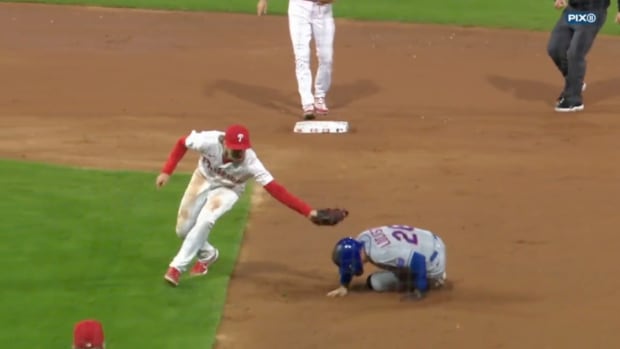 Tim Locastro slides in the middle of the basepath to avoid a tag