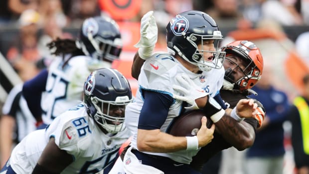 Sep 24, 2023; Cleveland, Ohio, USA; Cleveland Browns defensive end Alex Wright (91) sacks Tennessee Titans quarterback Ryan Tannehill (17) during the second half at Cleveland Browns Stadium. Mandatory Credit: Ken Blaze-USA TODAY Sports