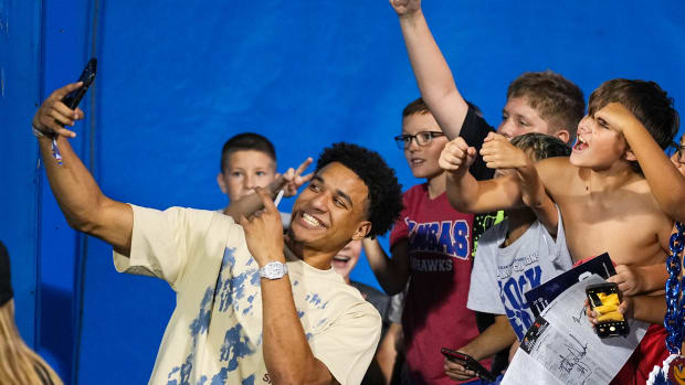 Sep 8, 2023; Lawrence, Kansas, USA; Kansas Jayhawks basketball player Kevin McCullar takes a photo with fans during the second half against the Illinois Fighting Illini at David Booth Kansas Memorial Stadium.