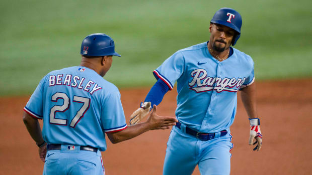 Sep 24, 2023; Arlington, Texas, USA; Texas Rangers second baseman Marcus Semien (2) rounds the bases past third base coach Tony Beasley (27) after Semien hits a lead off home run against the Seattle Mariners during the first inning at Globe Life Field.