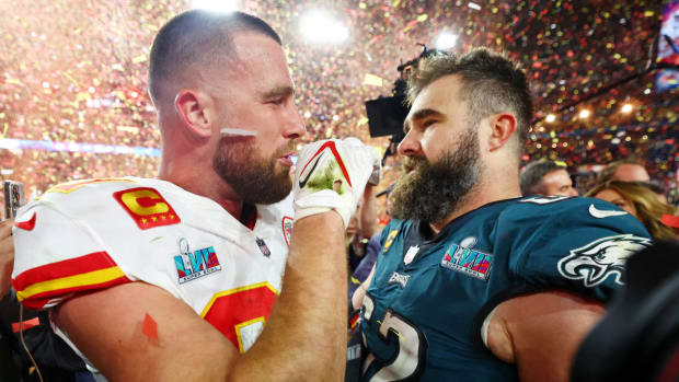Chiefs tight end Travis Kelce and Eagles center Jason Kelce talk after Super Bowl LVII.