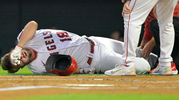 Sep 25, 2023; Anaheim, California, USA; Los Angeles Angels first baseman Nolan Schanuel (18) grimaces on the ground after fouling a ball off of his leg in the first inning against the Texas Rangers at Angel Stadium.