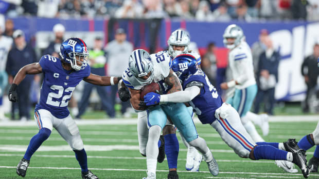 Sep 10, 2023; East Rutherford, New Jersey, USA; Dallas Cowboys running back Tony Pollard (20) fights for yards as New York Giants linebacker Bobby Okereke (58) tackles in front of cornerback Adoree' Jackson (22) during the second half at MetLife Stadium.