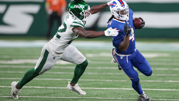 Jets' safety Tony Adams (22) attempts to tackle Bills' RB James Cook (4)