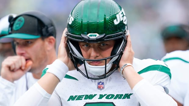 New York Jets quarterback Zach Wilson (2) puts on his helmet before walking onto the field to face the New England Patriots at MetLife Stadium on Sunday, Sept. 24, 2023, in East Rutherford.  