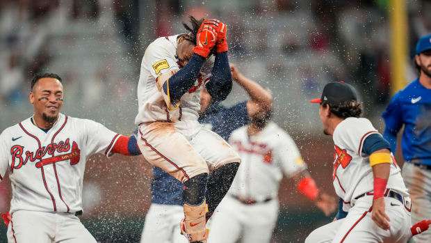 Sep 27, 2023; Cumberland, Georgia, USA; Atlanta Braves second baseman Ozzie Albies (1) gets splashed with water by teammates after getting the game winning hit against the Chicago Cubs during the tenth inning at Truist Park.