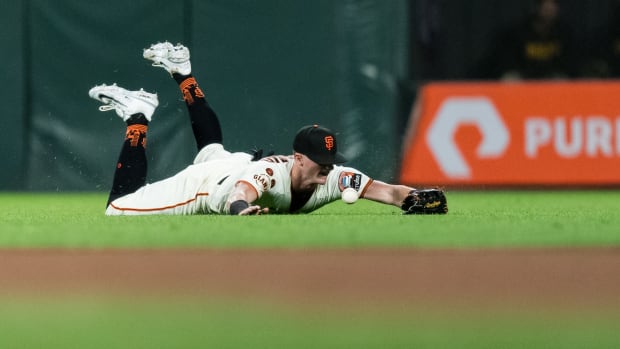SF Giants center fielder Tyler Fitzgerald (49) bobbles a catch against the San Diego Padres at Oracle Park (2023).