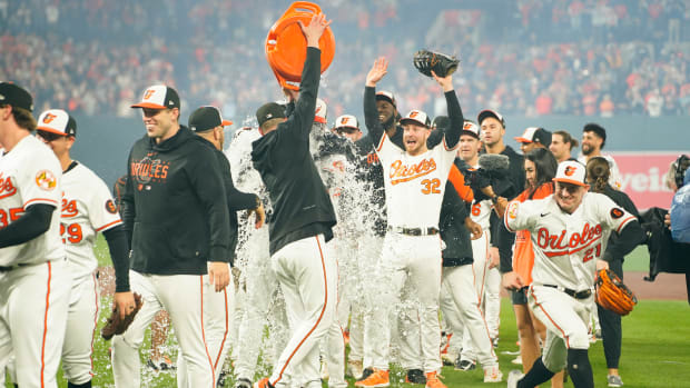 Sep 28, 2023; Baltimore, Maryland, USA; Baltimore Orioles manager Brandon Hyde (18) get doused with Gatorade as the Baltimore Orioles celebrates clinching the American League East Division after the game against the Boston Red Sox at Oriole Park at Camden Yards.